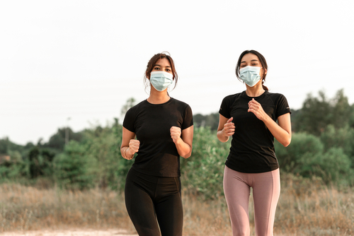 Beautiful,Asian,Teenagers,Doing,Exercise,While,Wearing,Face,Mask
